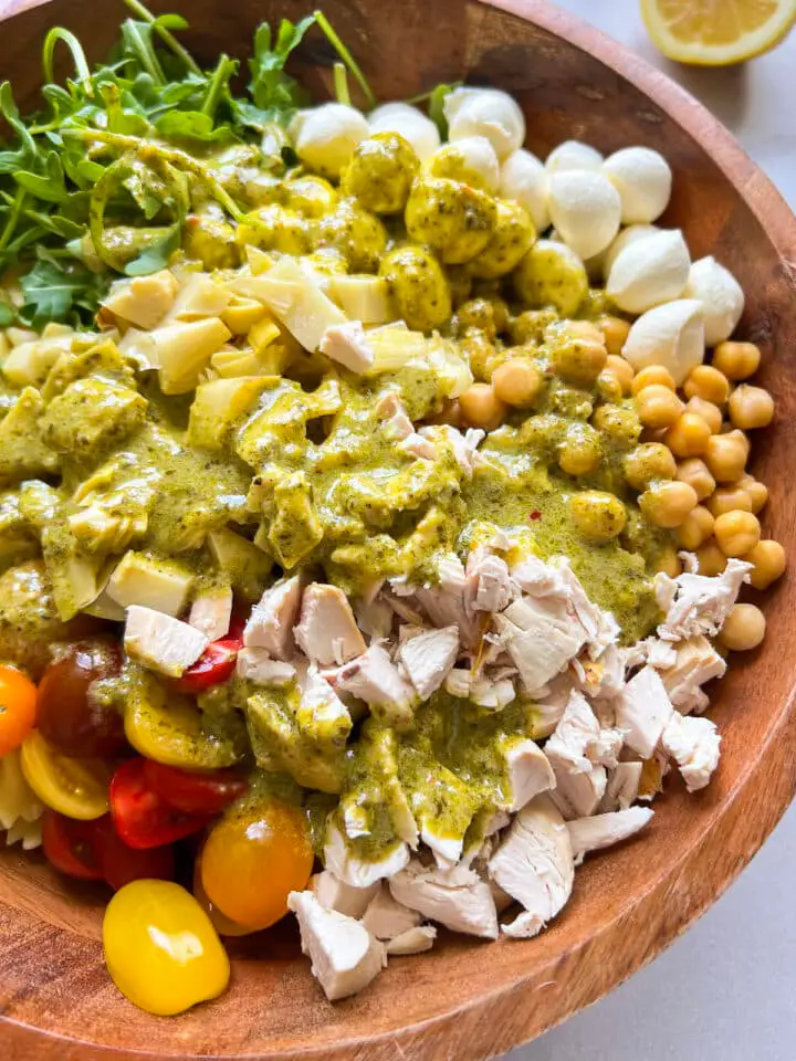 Chicken pesto pasta salad with grilled chicken, green pesto sauce, and penne pasta