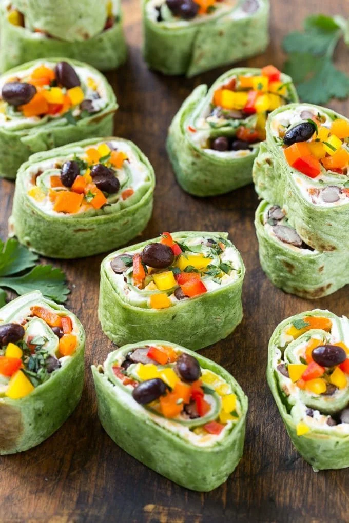 Mexican tortilla pinwheels filled with creamy cheese, green chiles, and spices, sliced into bite-sized appetizers