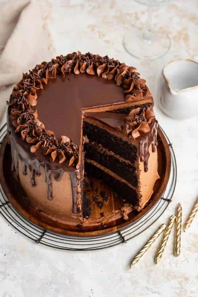 "Rich homemade chocolate cake with moist layers and smooth chocolate frosting."