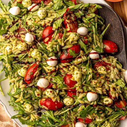 Chicken Pesto Orzo Salad with fresh vegetables and basil pesto served in a bowl – healthy and colorful pasta salad