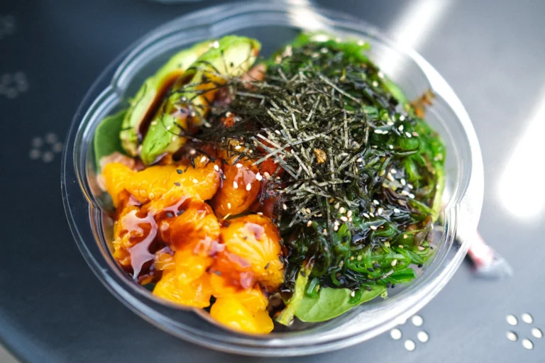 Healthy rice bowl with vegetables and avocado, ready to top with air fryer salmon bites