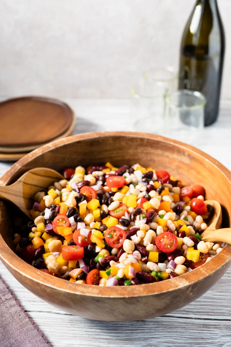 Bowl of black bean quinoa salad with corn, peppers, and fresh herbs