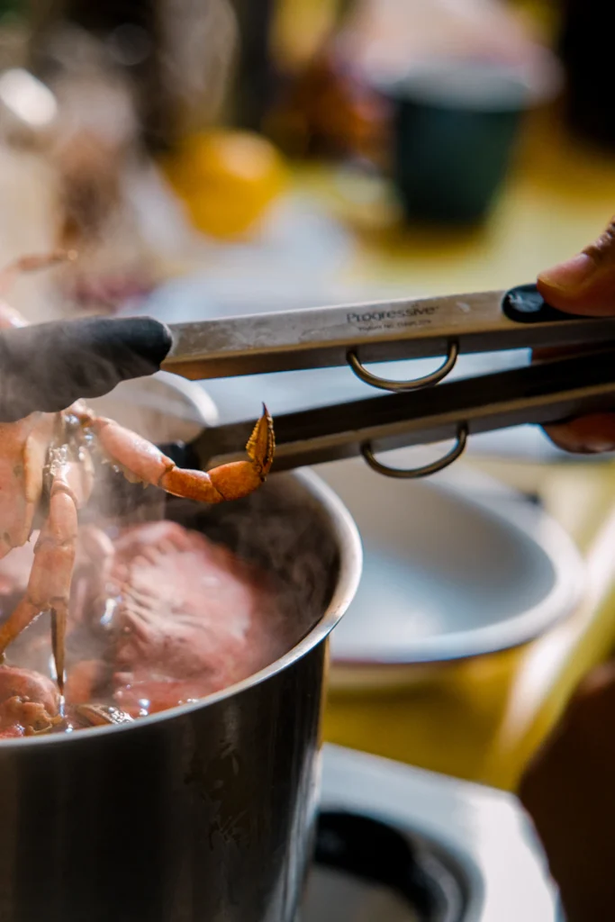 Whole chicken simmering in a pot of broth