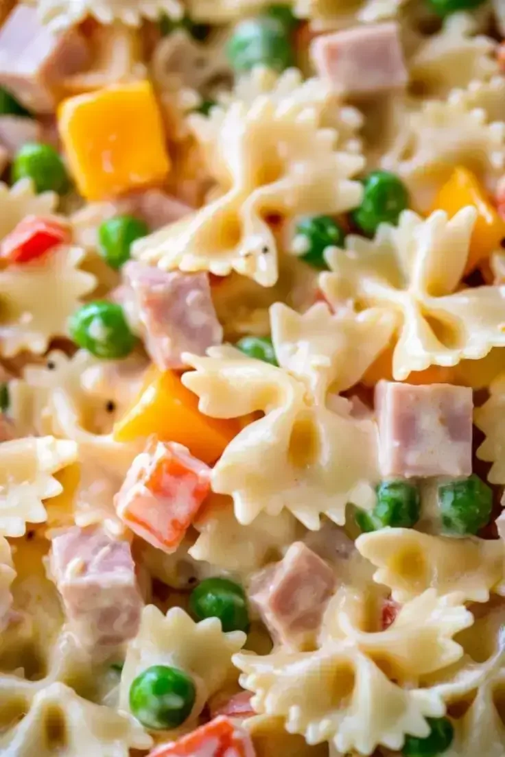 Creamy bow tie pasta salad with chicken, peas and cheddar