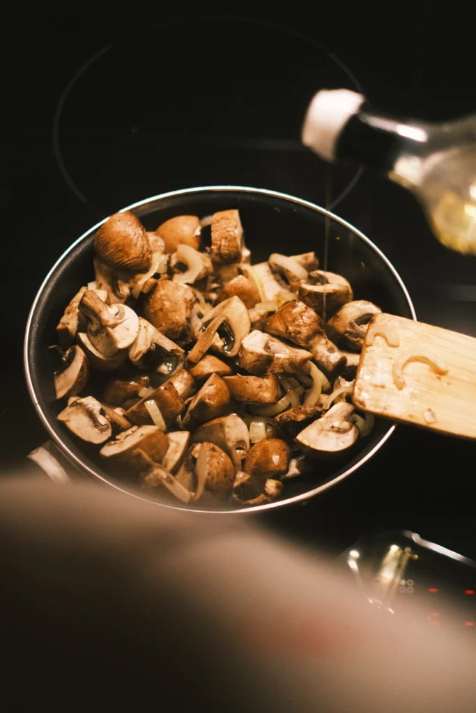 Mushrooms browning in a skillet until golden