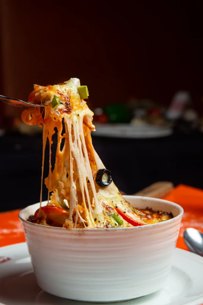 Stretchy melted mozzarella lifted from a baked pasta