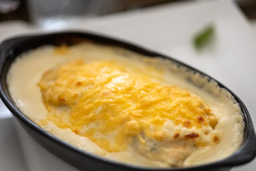 Close up of a cheesy chicken bake with a bubbly golden top