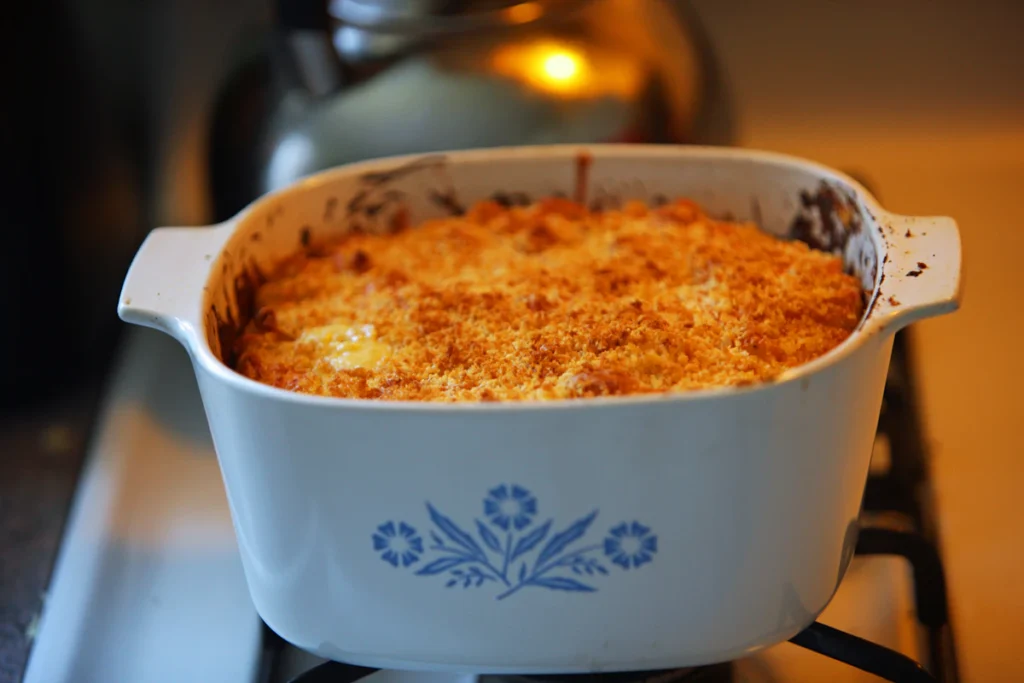 Casserole dish of baked chicken resting on the stove