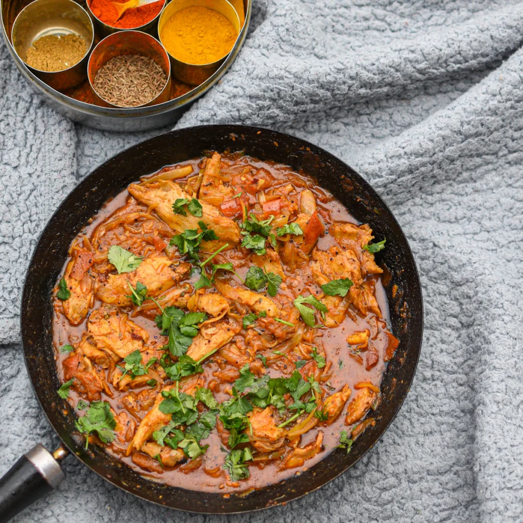 Chicken curry simmering in a pan