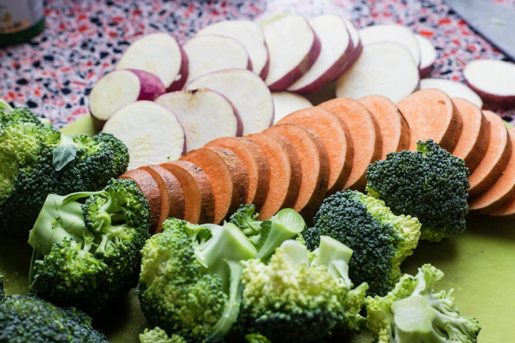 Fresh broccoli and sliced sweet potato for chicken meal prep bowls
