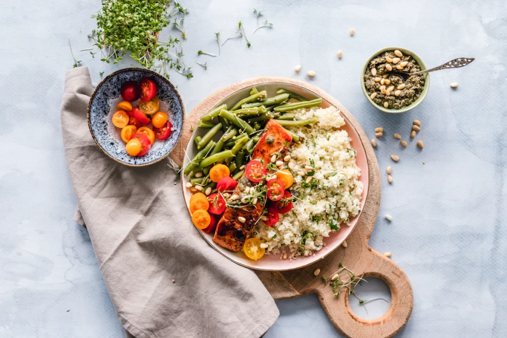 Colorful grain and vegetable bowl served on a wooden board
