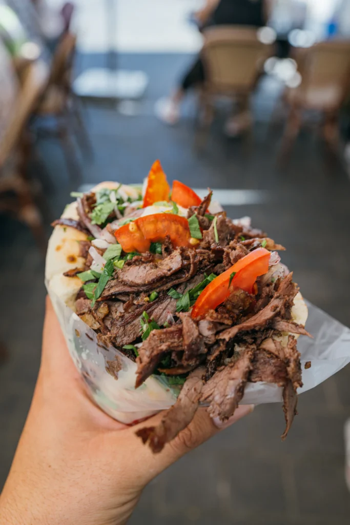 Shredded chicken shawarma piled with fresh vegetables