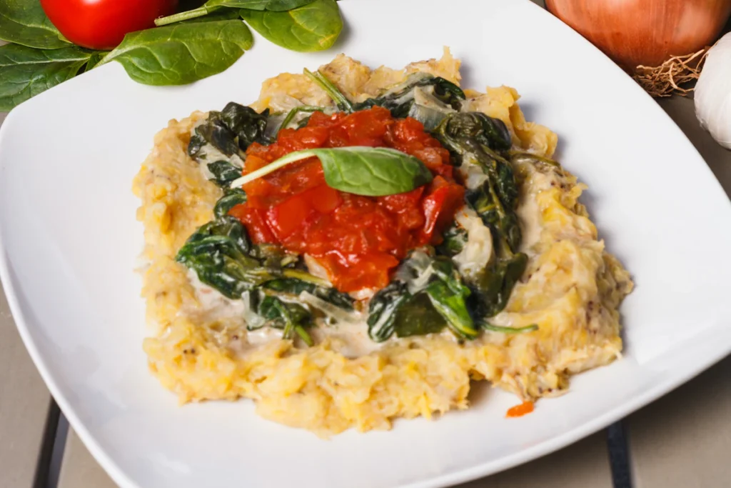 Chicken served over spinach