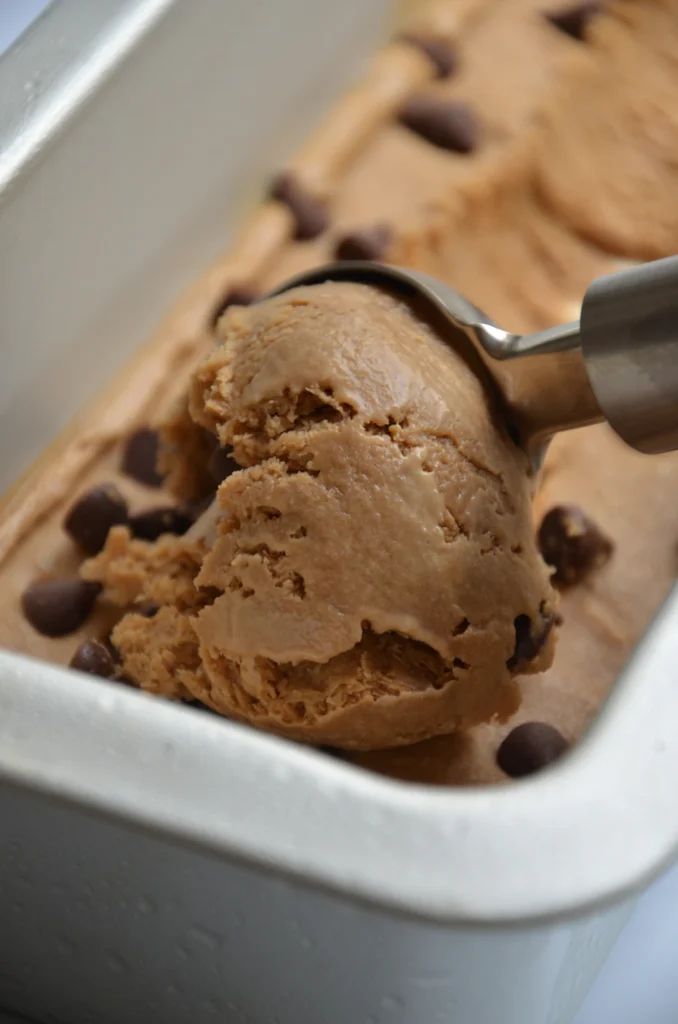 Scoops of chocolate ice cream on a white tray