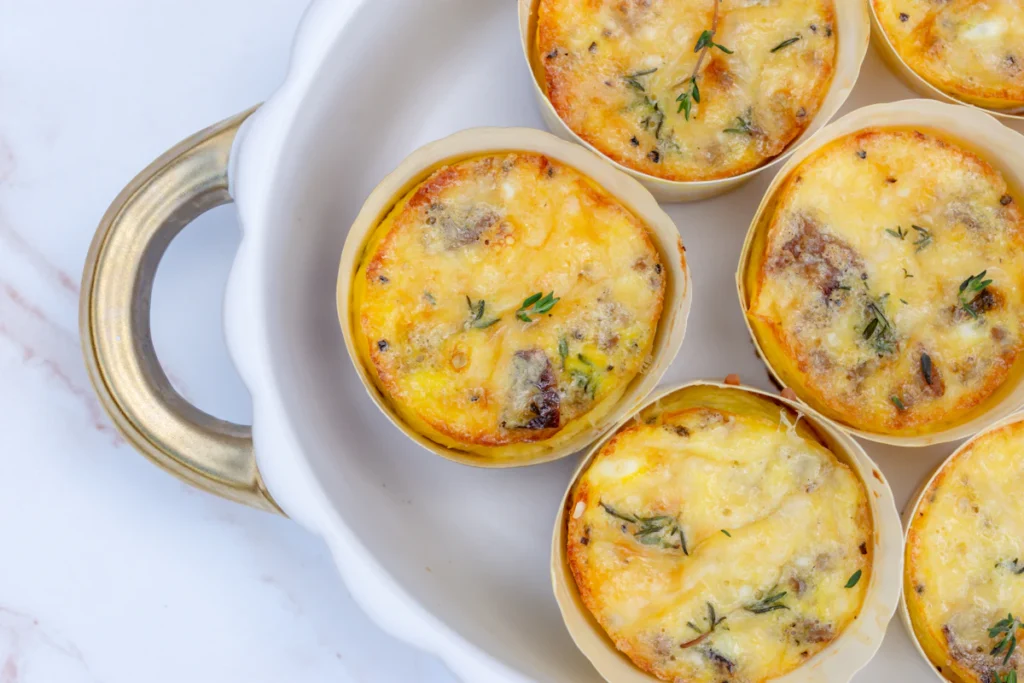 Creamy cottage cheese egg bites with spinach and peppers on a white plate