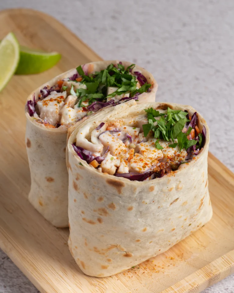 High protein flatbread wraps filled with chicken, cabbage, and fresh herbs