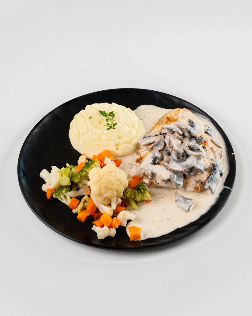 Creamy pepperoncini chicken plated with vegetables