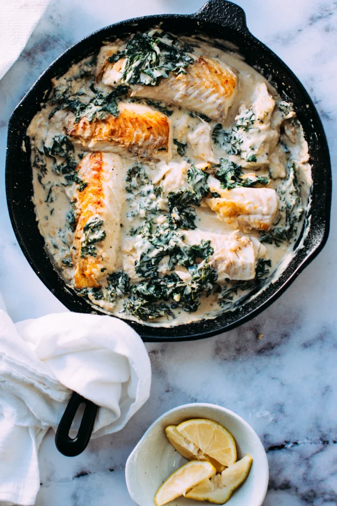 Creamy chicken skillet with greens in a cast iron pan