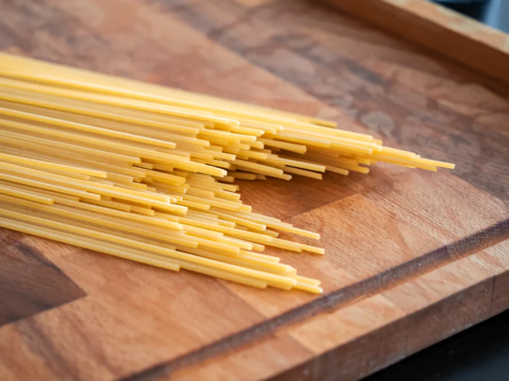 Dry spaghetti on a wooden board, the main ingredient for baked spaghetti casserole