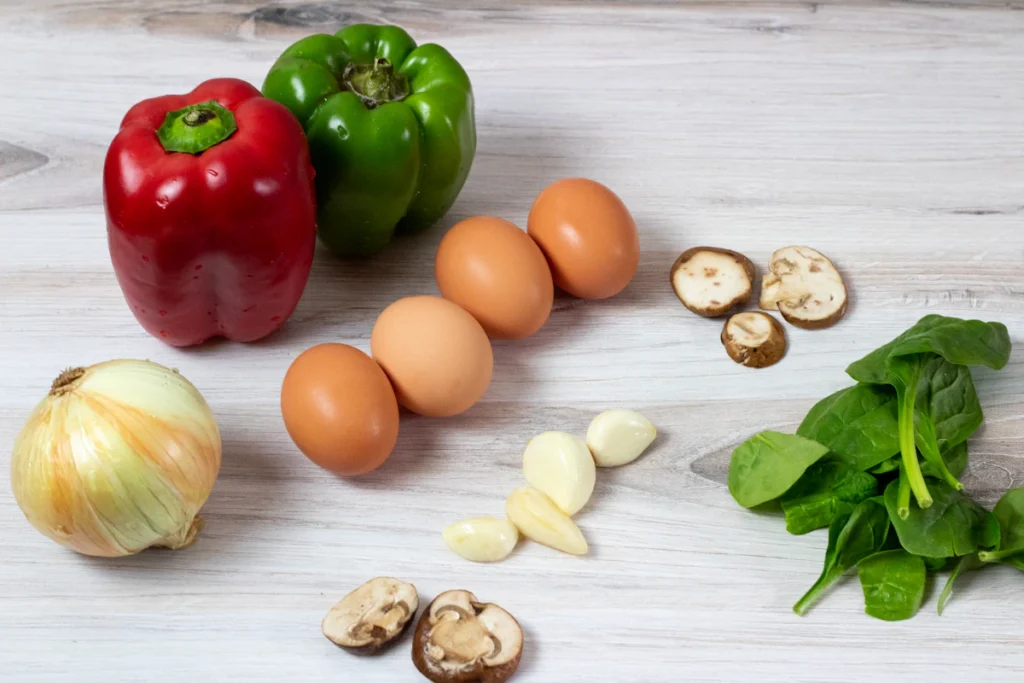 Egg bites ingredients: eggs, red bell pepper, onion, mushrooms, and spinach