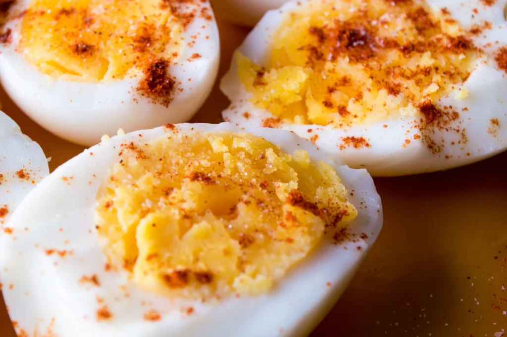 Sliced boiled eggs topped with paprika and spices