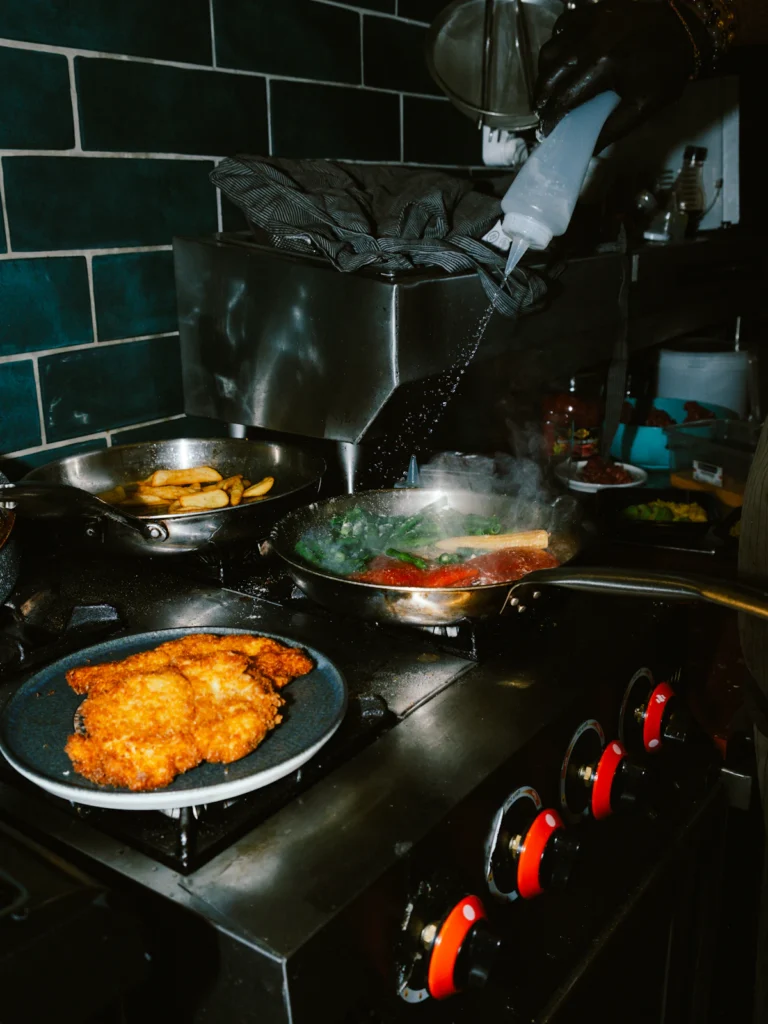 Frying breaded chicken cutlets in a pan