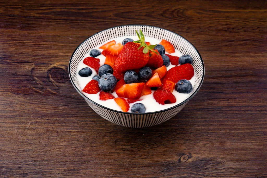 Bowl of Greek yogurt with fresh strawberries and blackberries