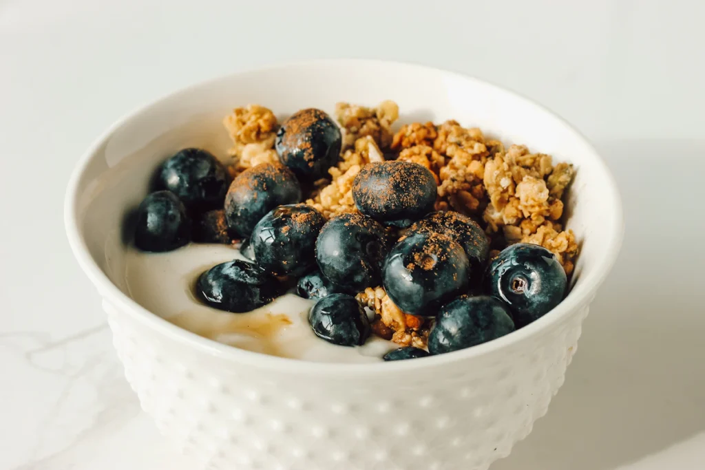Creamy breakfast bowl topped with blueberries and granola