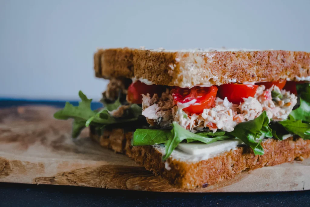 Greek yogurt chicken salad sandwich with lettuce on whole grain bread