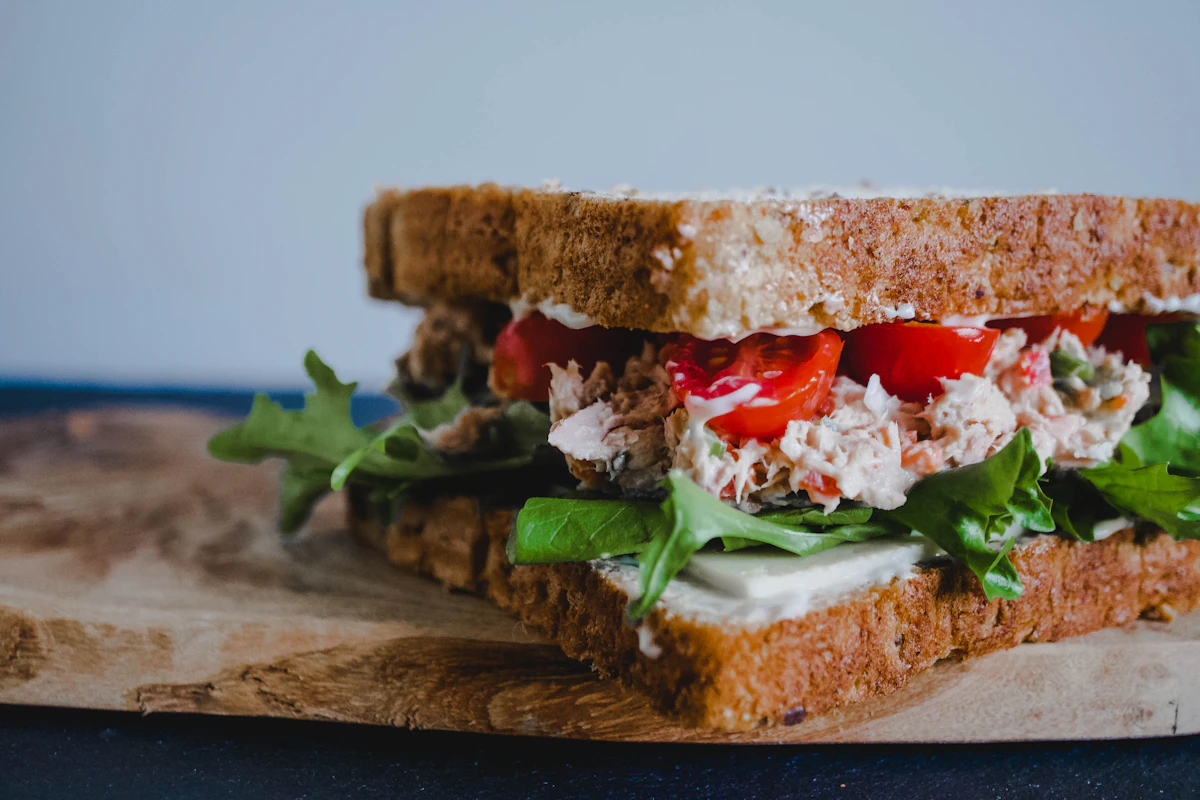 Greek yogurt chicken salad sandwich with lettuce on whole grain bread