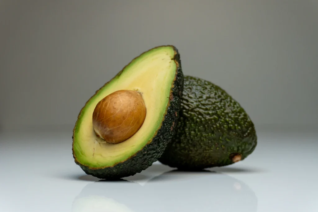 Halved ripe avocado for chickpea salad wraps
