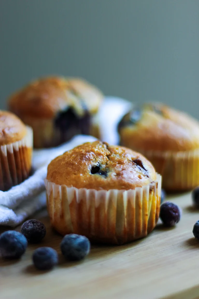 High protein blueberry muffins with tall golden tops and juicy berries