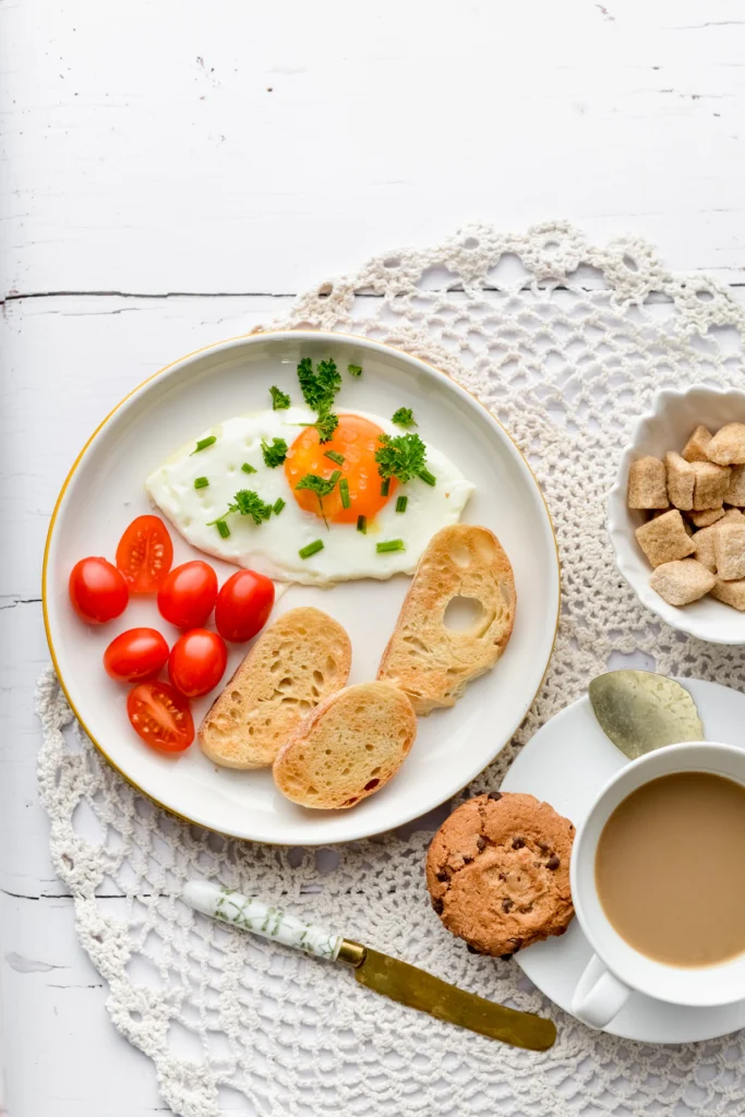 High protein breakfast plate with eggs, toast, and fresh tomatoes