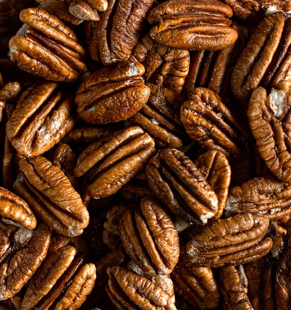 Pile of pecans, toasted and chopped for crunch in chicken salad