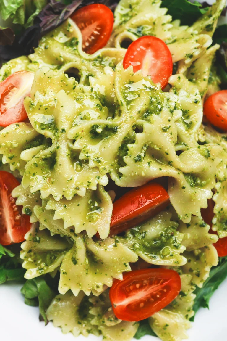 Pesto chicken pasta salad with cherry tomatoes and fresh basil
