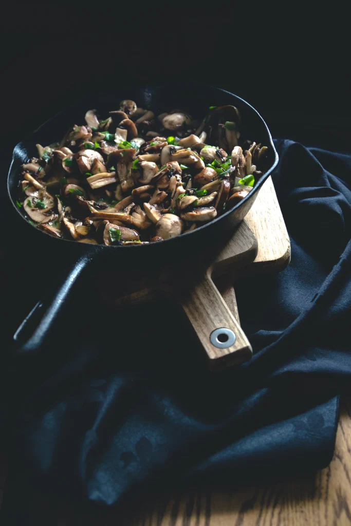 Mushrooms sautéing with garlic in a pan