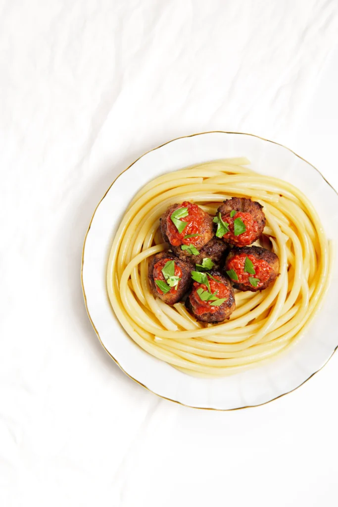 Spaghetti and meatballs on a white plate