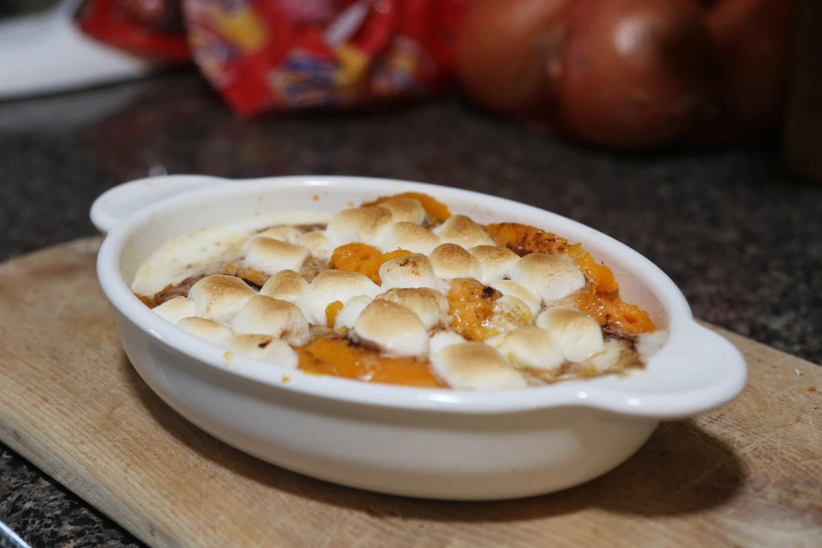 Sweet potato casserole baked in a white dish, ready for the holiday table