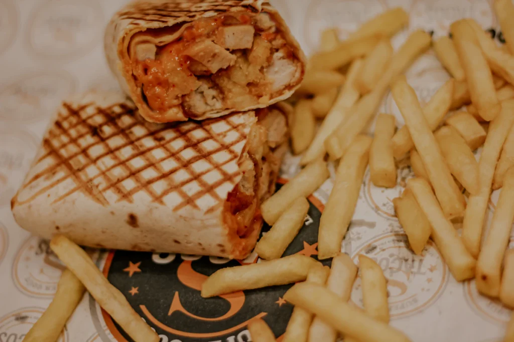 Toasted chicken burrito served with fries
