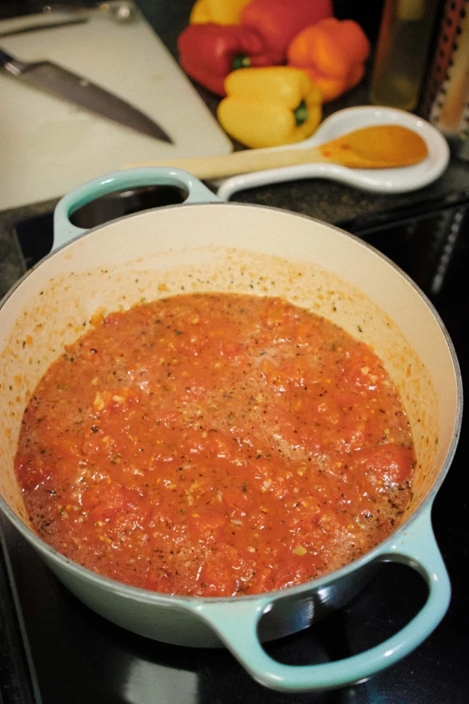 Tomato sauce simmering in a pot on the stove