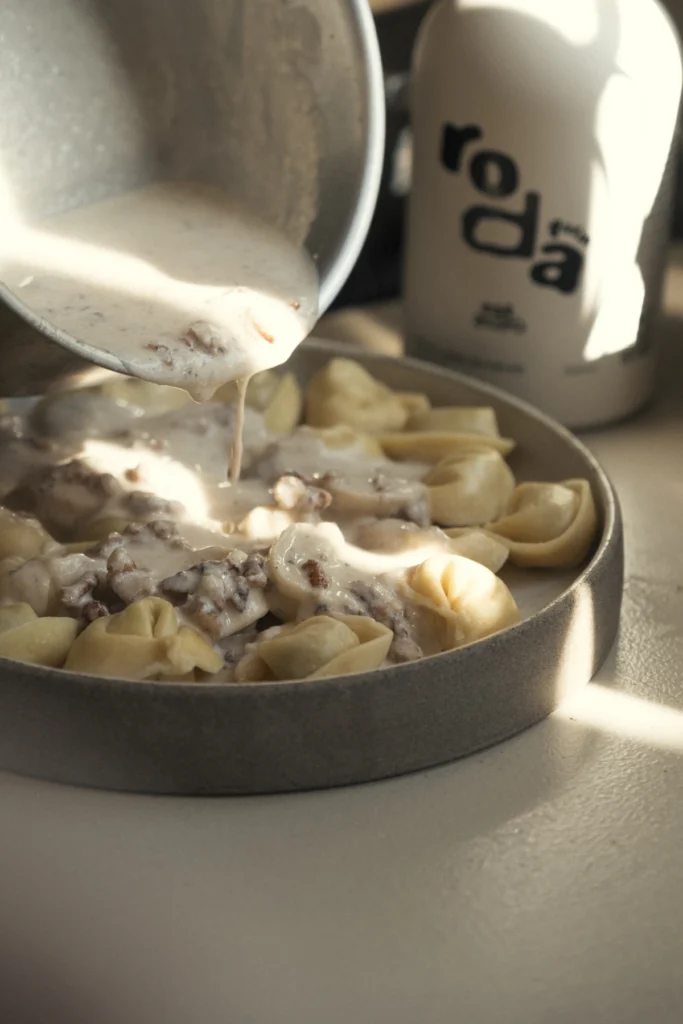 Tortellini simmering in a cream sauce