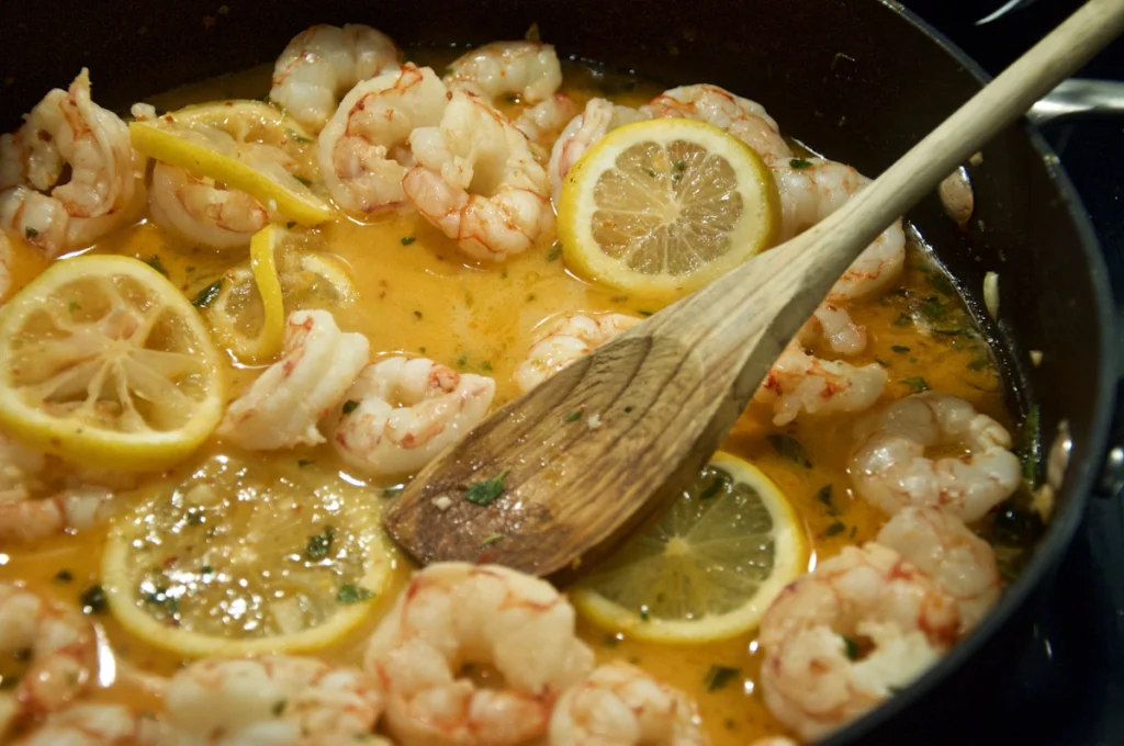 Tossing linguine with shrimp and sauce