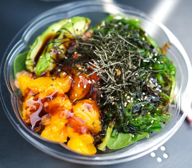 Healthy rice bowl with vegetables and avocado, ready to top with air fryer salmon bites