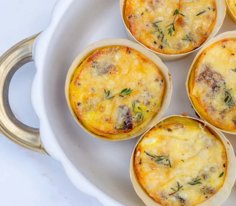 Creamy cottage cheese egg bites with spinach and peppers on a white plate