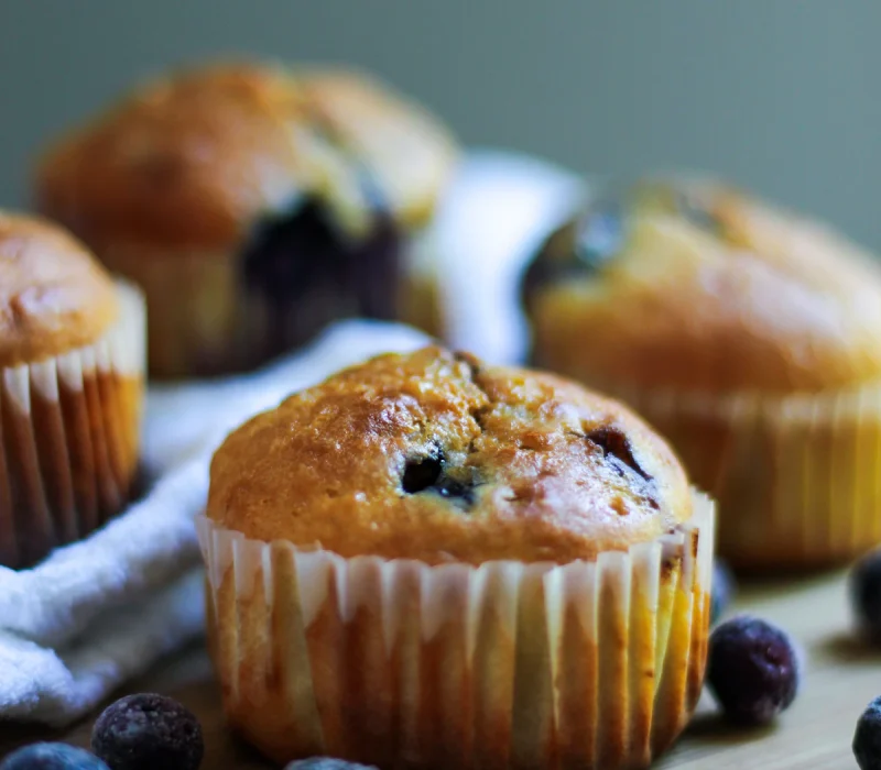 High protein blueberry muffins with tall golden tops and juicy berries