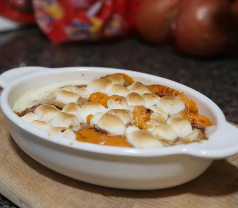 Sweet potato casserole baked in a white dish, ready for the holiday table